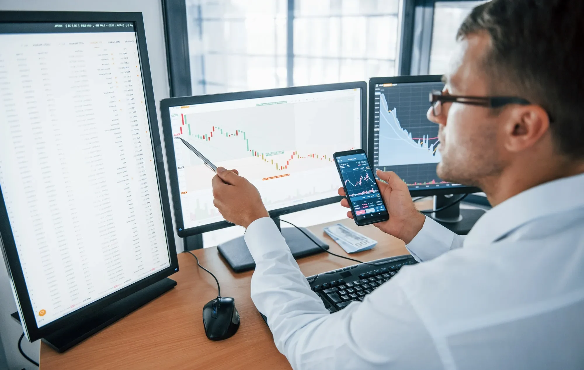 خدمات مالیاتی و حسابداری حرفه ای | نوین تکس 4 young businessman in formal clothes is in office with multiple screens e1735584792958